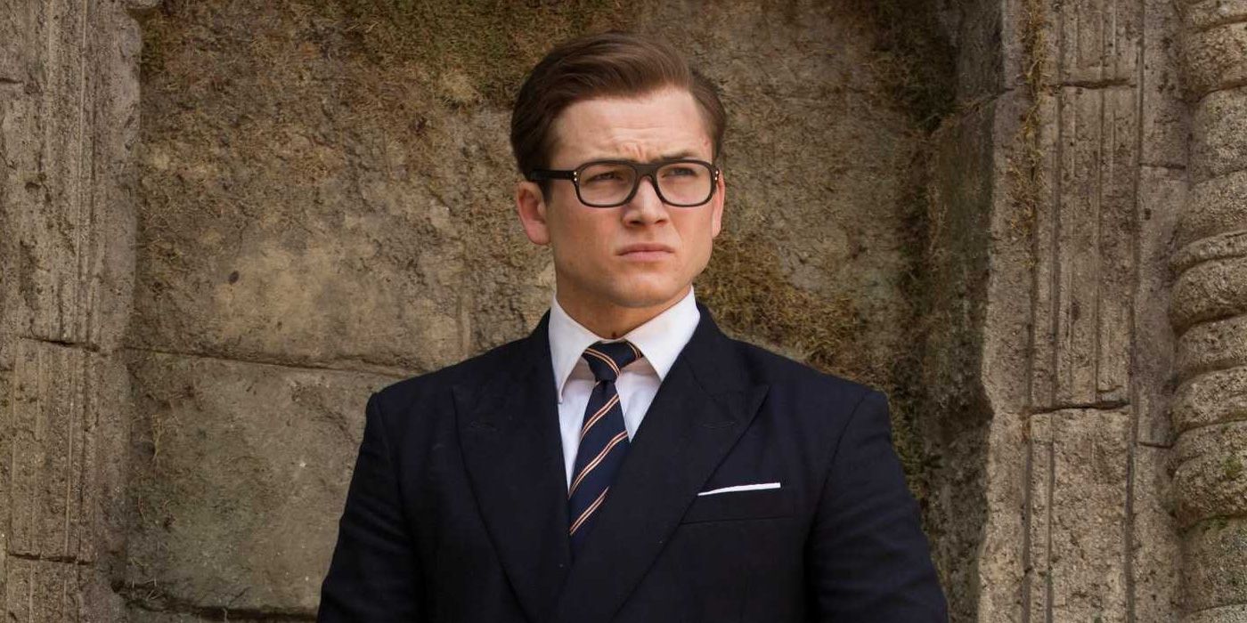 Eggsy looks off into the distance at Kingsman.