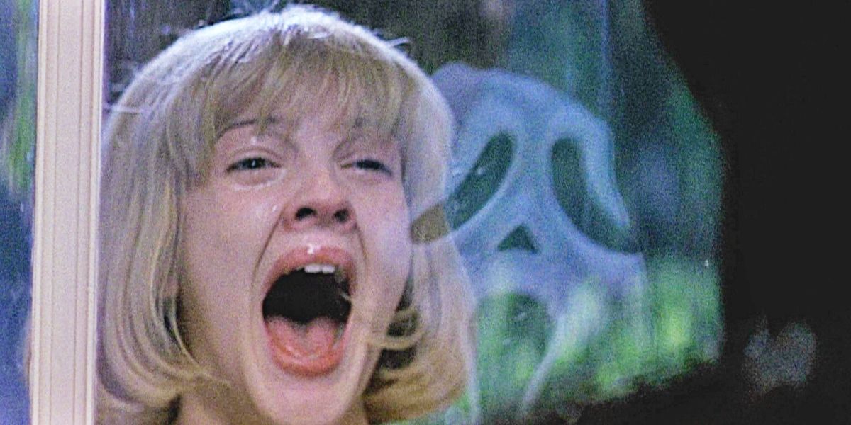 The girl screams, looking at the killer through the window