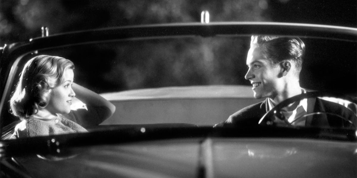 Mary Sue and Skip smile at each other in a car in Pleasantville.