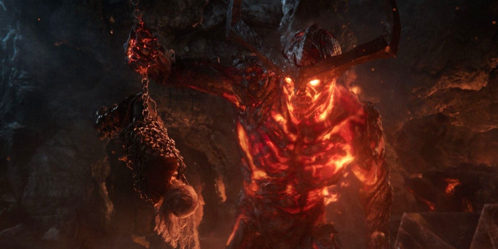 The fiery demon Surtur talks to the shackled Thor in Thor: Ragnarok.