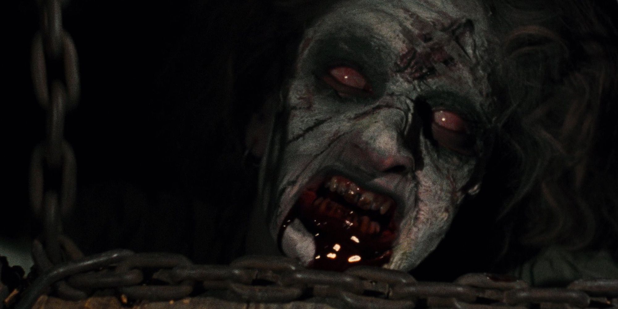 Evil Dead Deadite peeking out from under the floor with a bloody mouth
