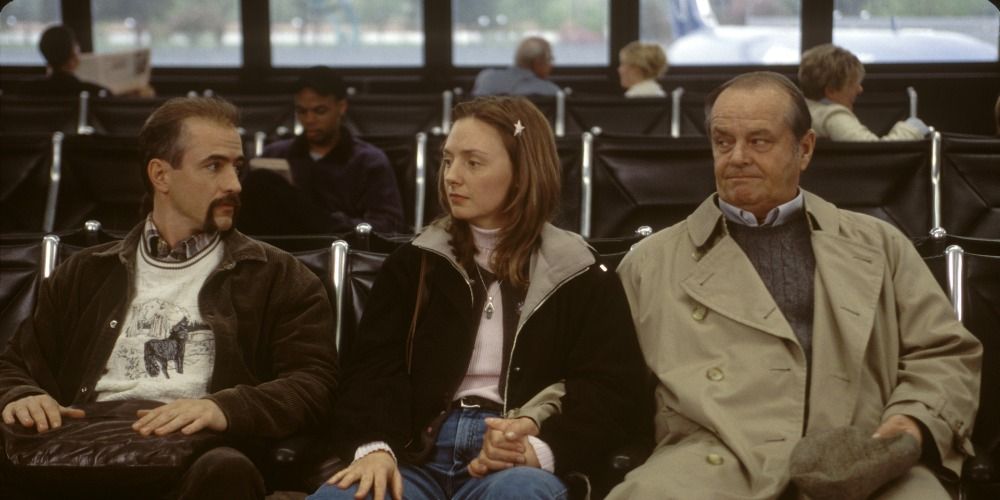 A young couple and an older man sit side by side and look awkward in 