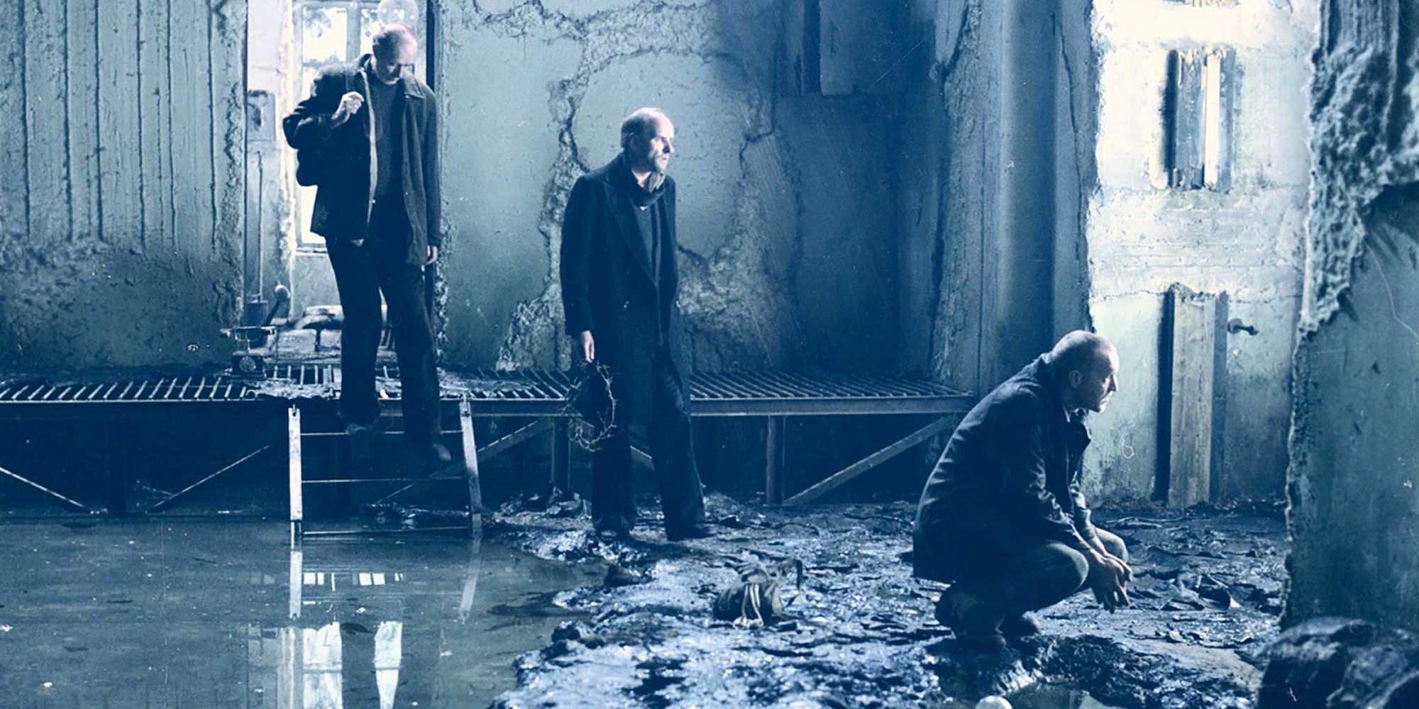 three men enter a room in ruins, a large pond on the ground