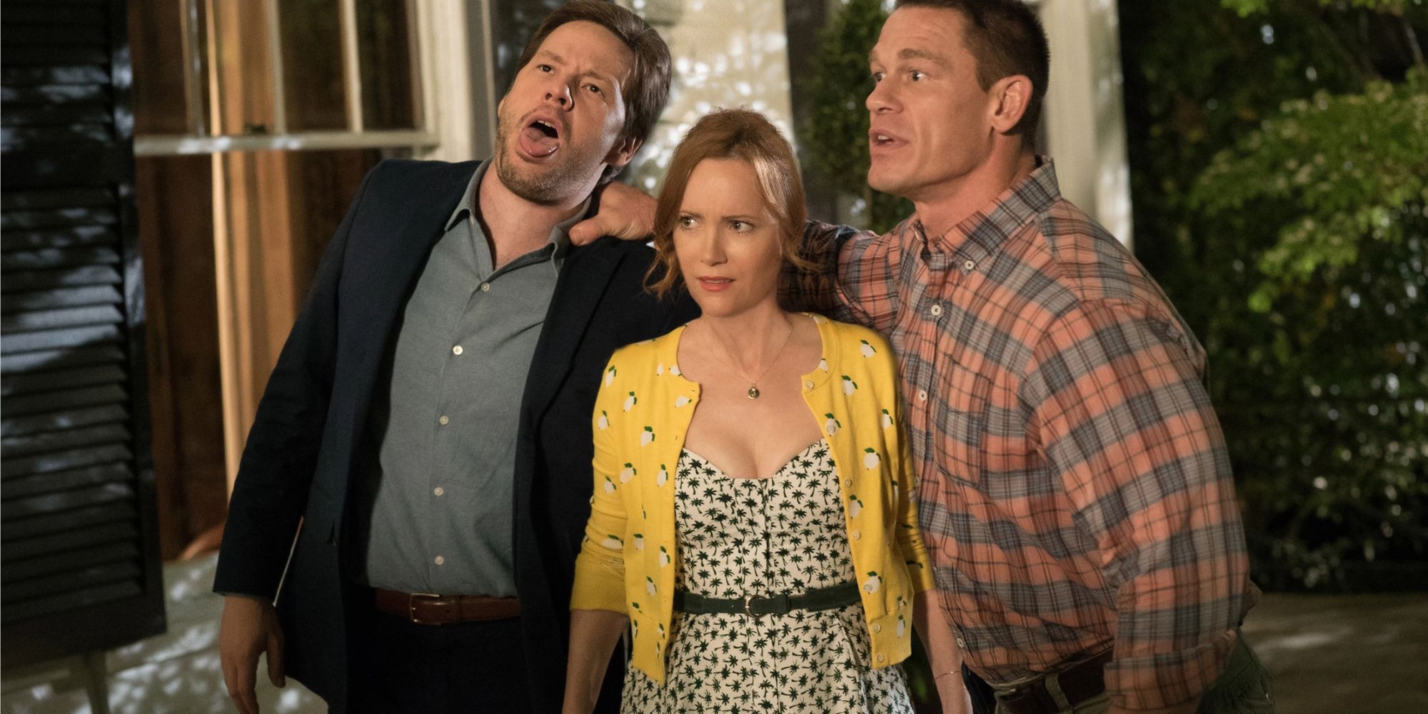 Ike Barinholtz, Leslie Mann and John Cena hold each other and look confused