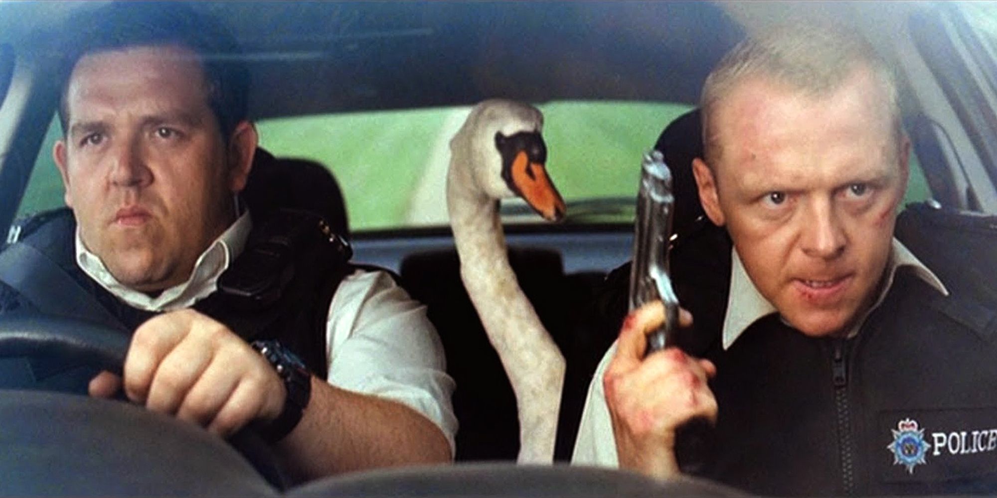 Two policemen ride with a swan between them
