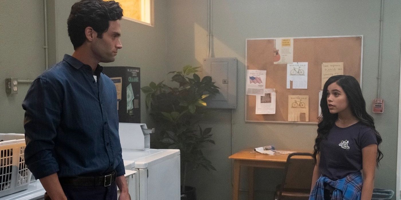 Jenna Ortega as Ellie talks to Penn Badgley's Joe Goldberg in the laundry room during the second season of You.