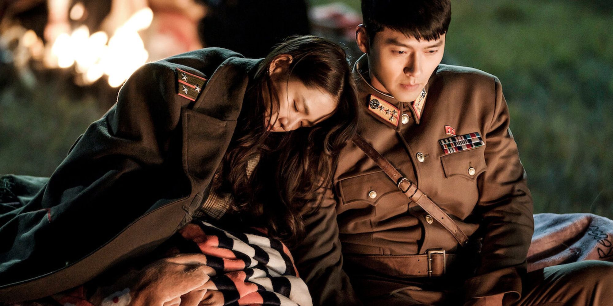 Yoon Se Ri and Ri Jong Hyuk from “Crash Landing on Love” sit by the fire