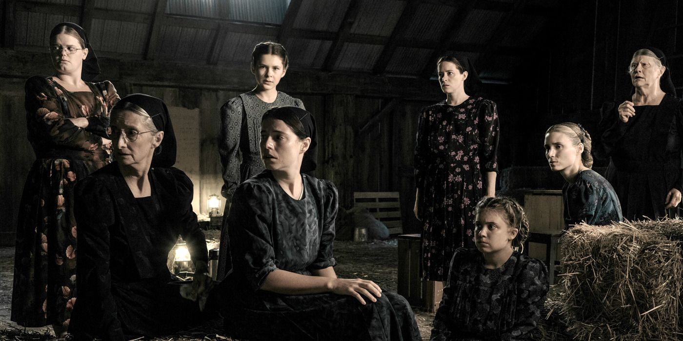 A group of women gather in a barn