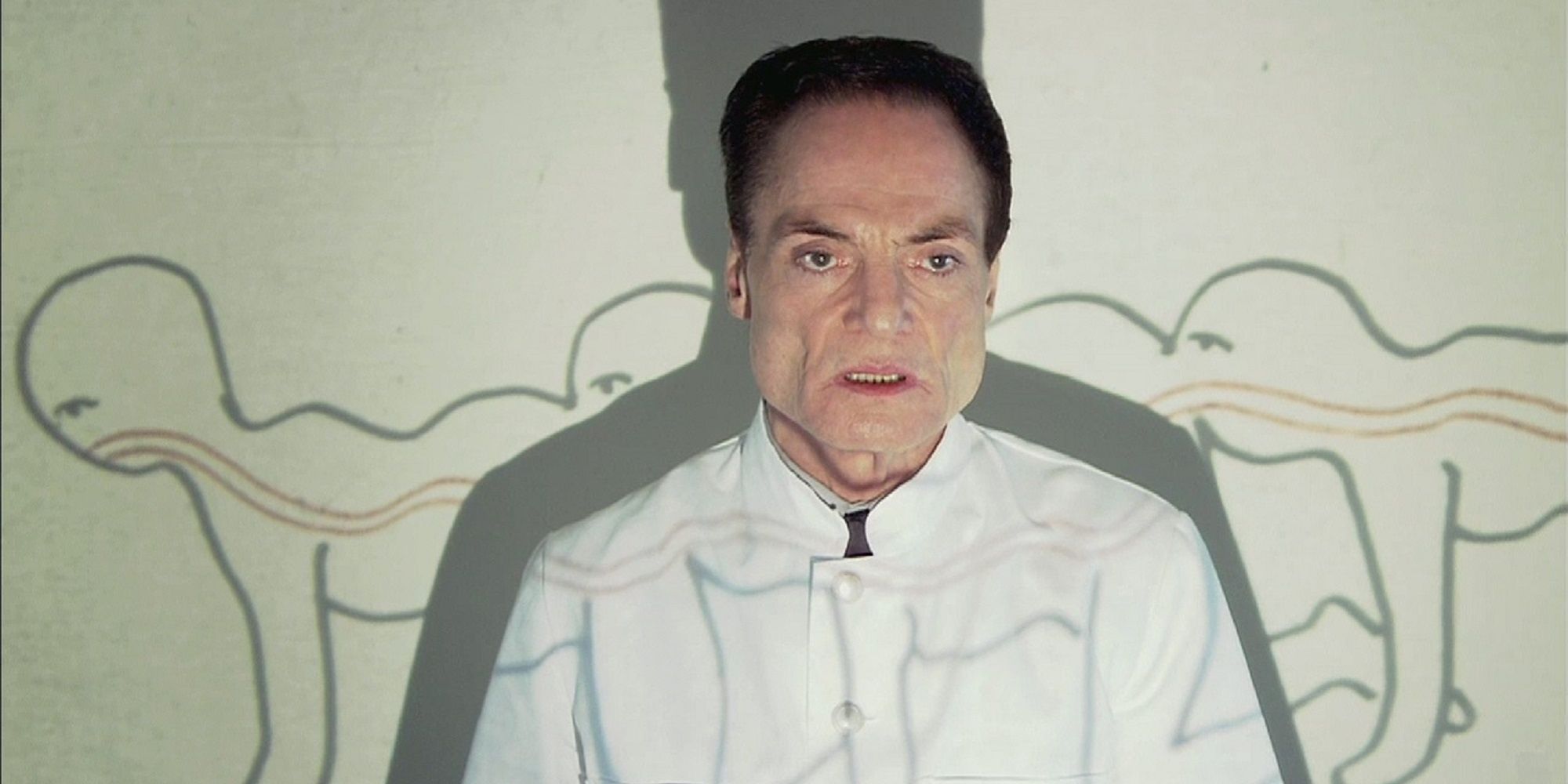 Josef Heiter at the wall with a projection of a human centipede.