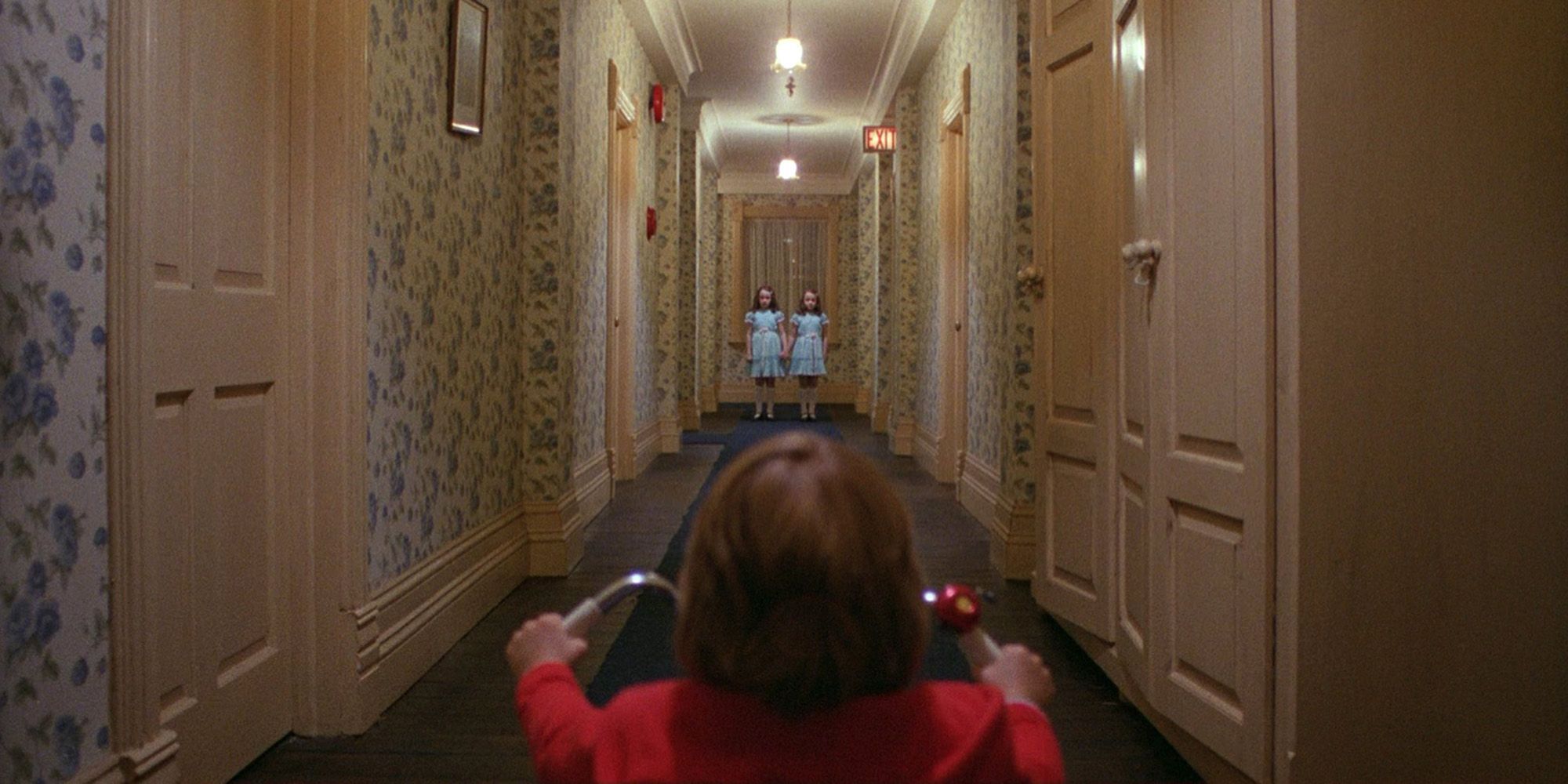 Danny looks at the twins in the lobby of the Overlook Hotel from The Shining.