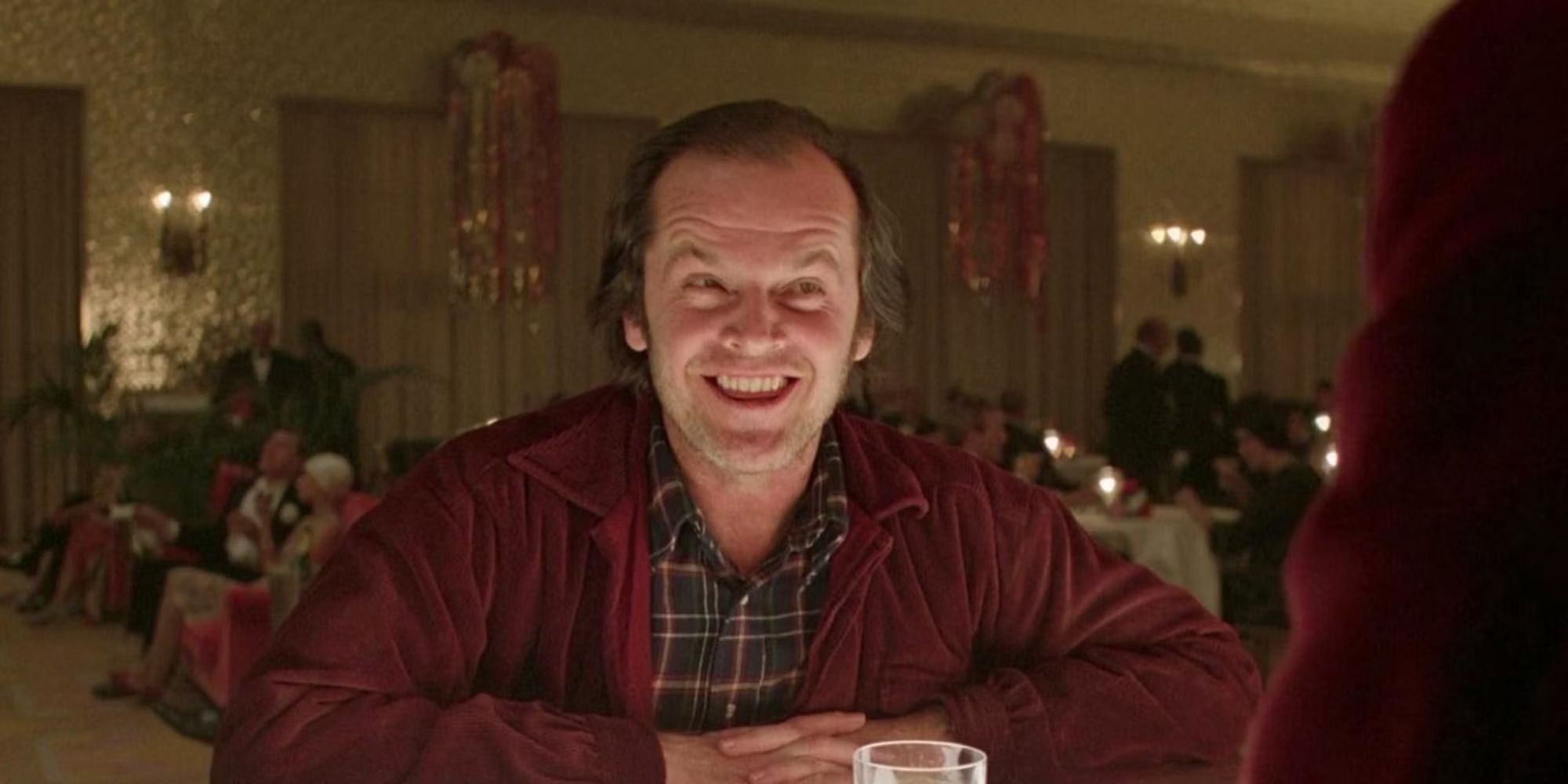 Jack Torrance (Jack Nicholson) smiles at the bar in The Shining.