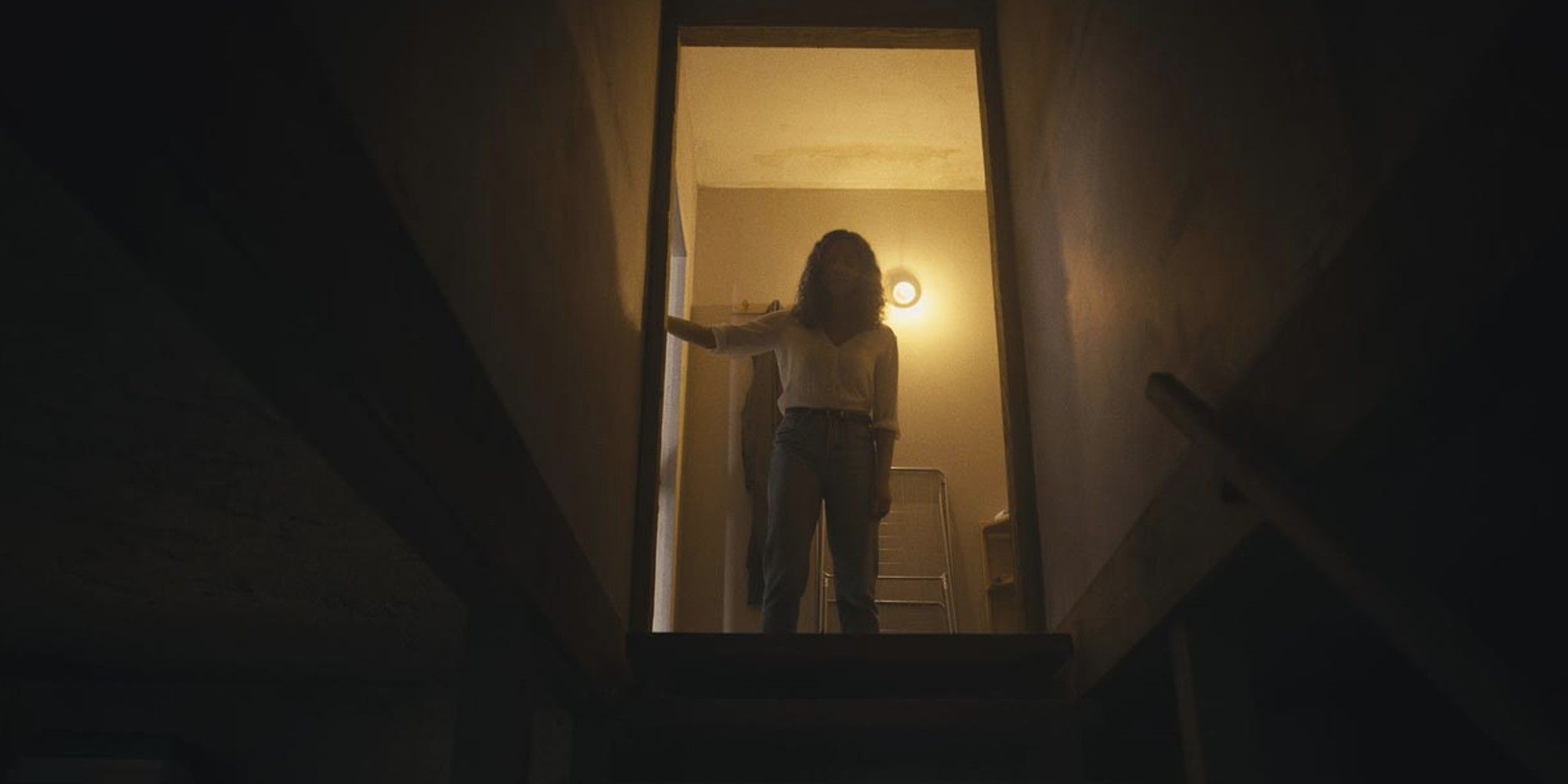 Georgina Campbell's character looks down the stairs in The Barbarian.