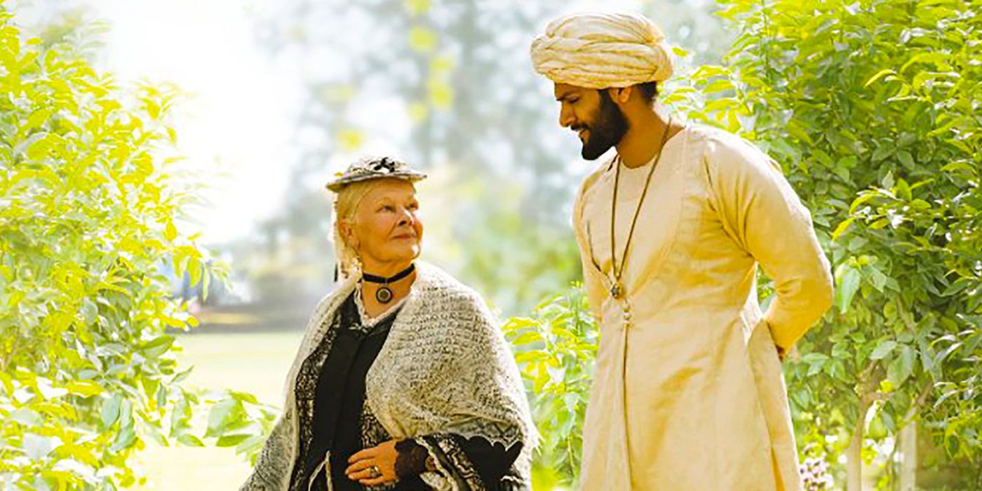 Victoria and Abdul are walking in the garden in Victoria and Abdul.
