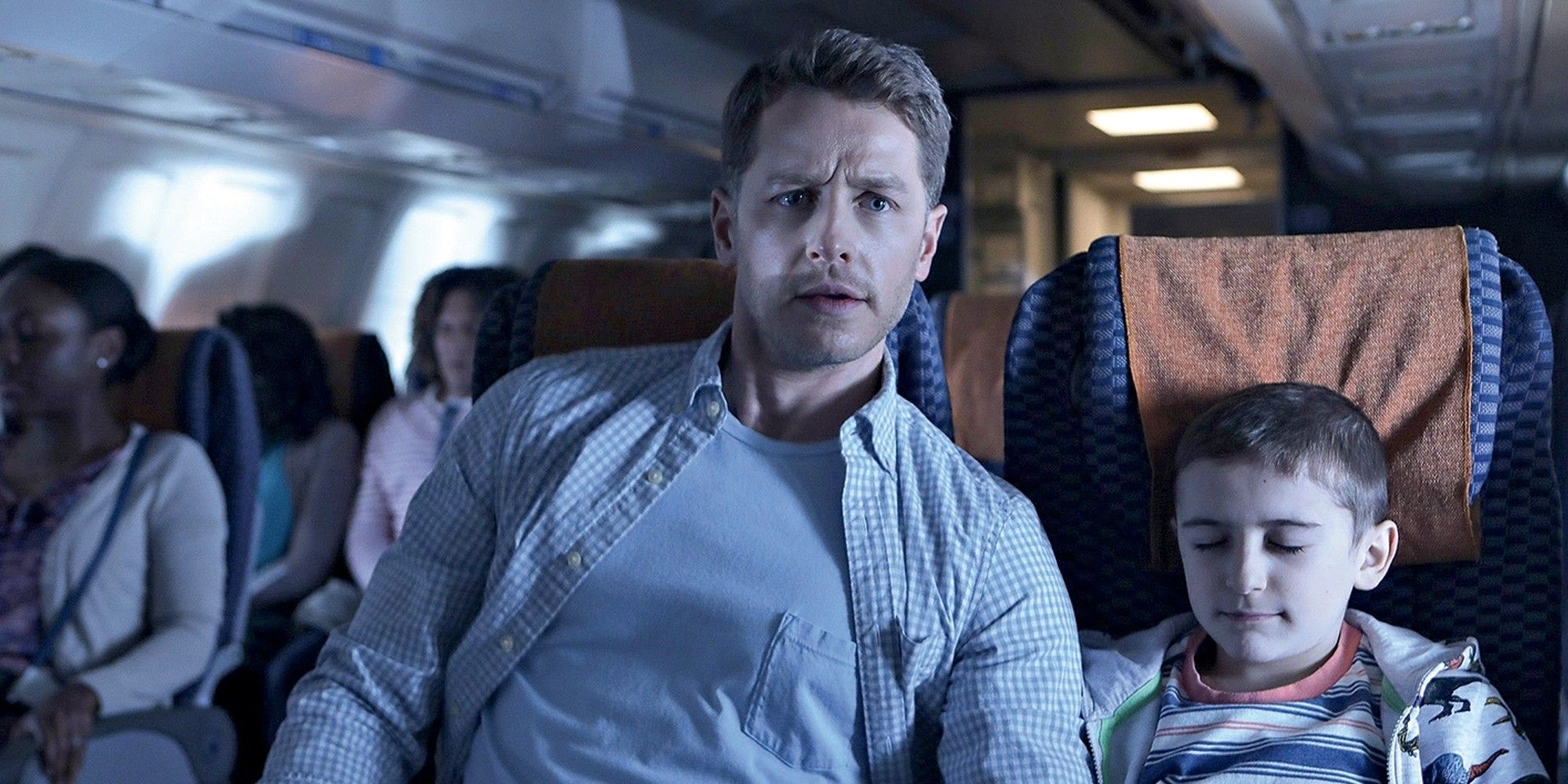 A man sits next to a boy on a plane in Manifesto.