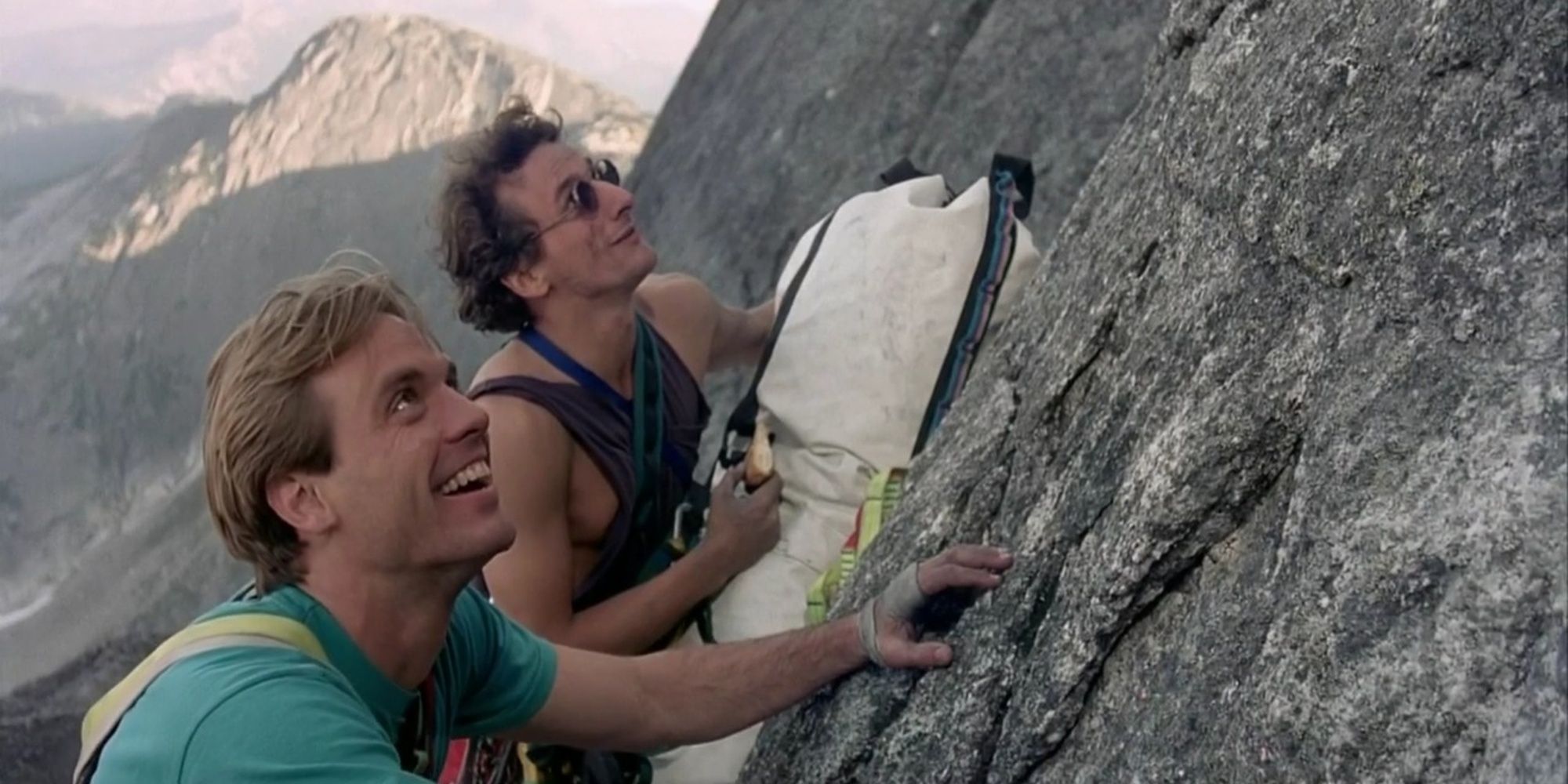 Two men climb a mountain