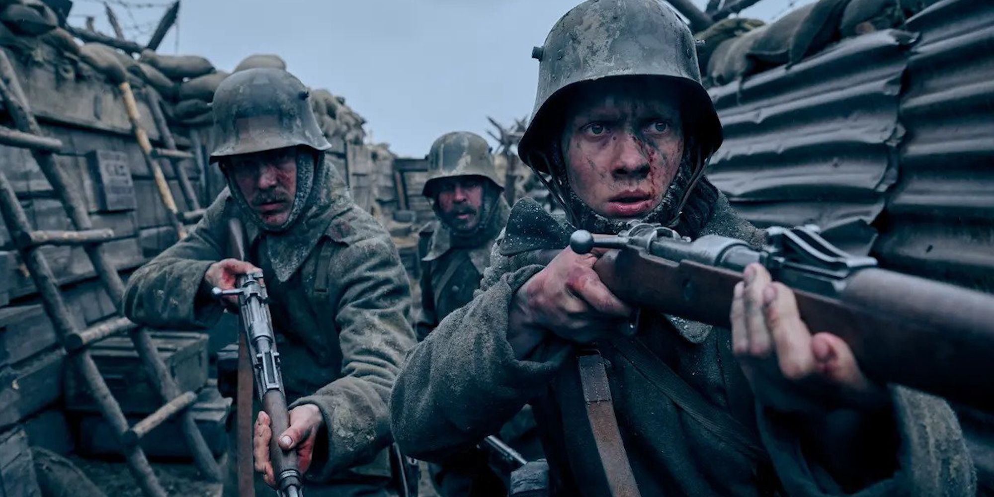 Three soldiers in the trenches in the film All Quiet on the Western Front.
