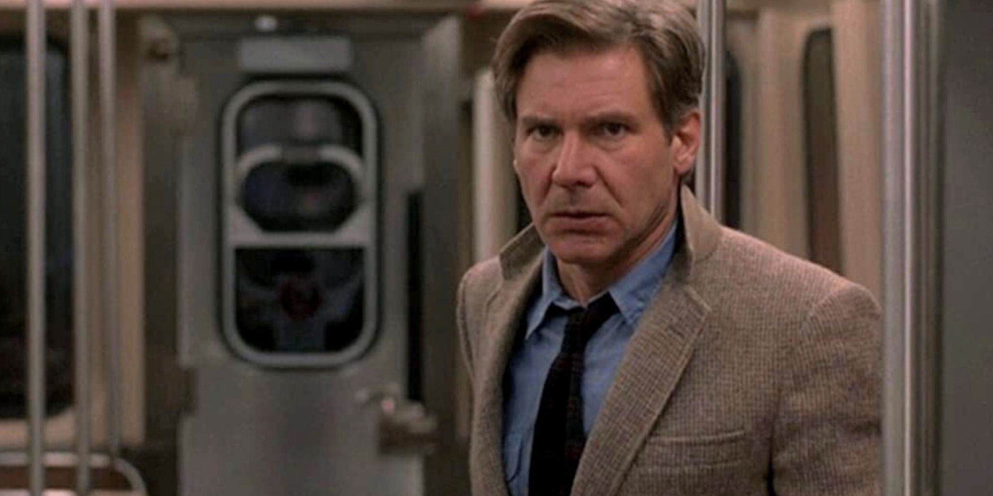 Richard Kimble stands alone in a subway car looking ahead in The Fugitive.
