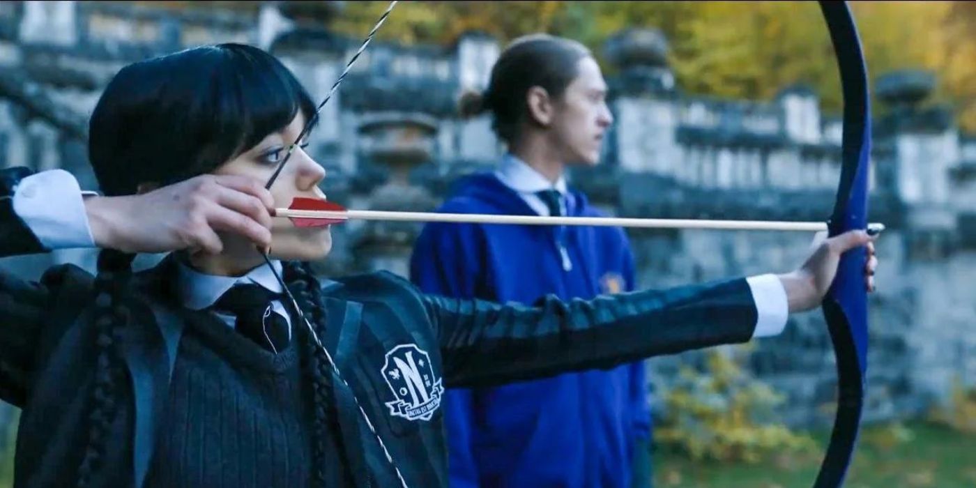 Wednesday, played by Jenna Ortega, shoots a bow and arrow, while Xavier, played by Percy Hynes White, watches Netflix's Wednesday.