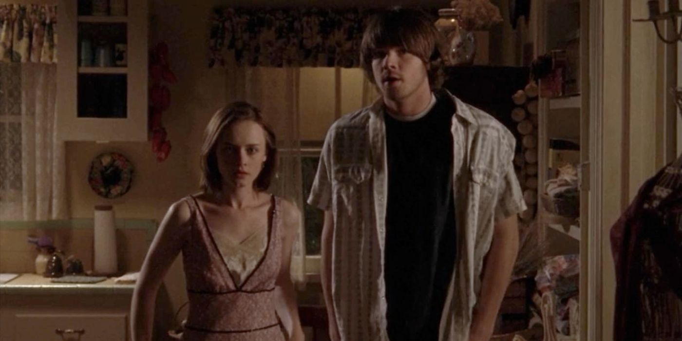 Rory and Dean stand side by side in Gilmore Girls.