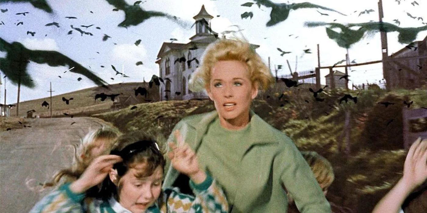 Melanie, played by Tippi Hedren, runs with a little girl from a flock of attacking birds in Alfred Hitchcock's The Birds.