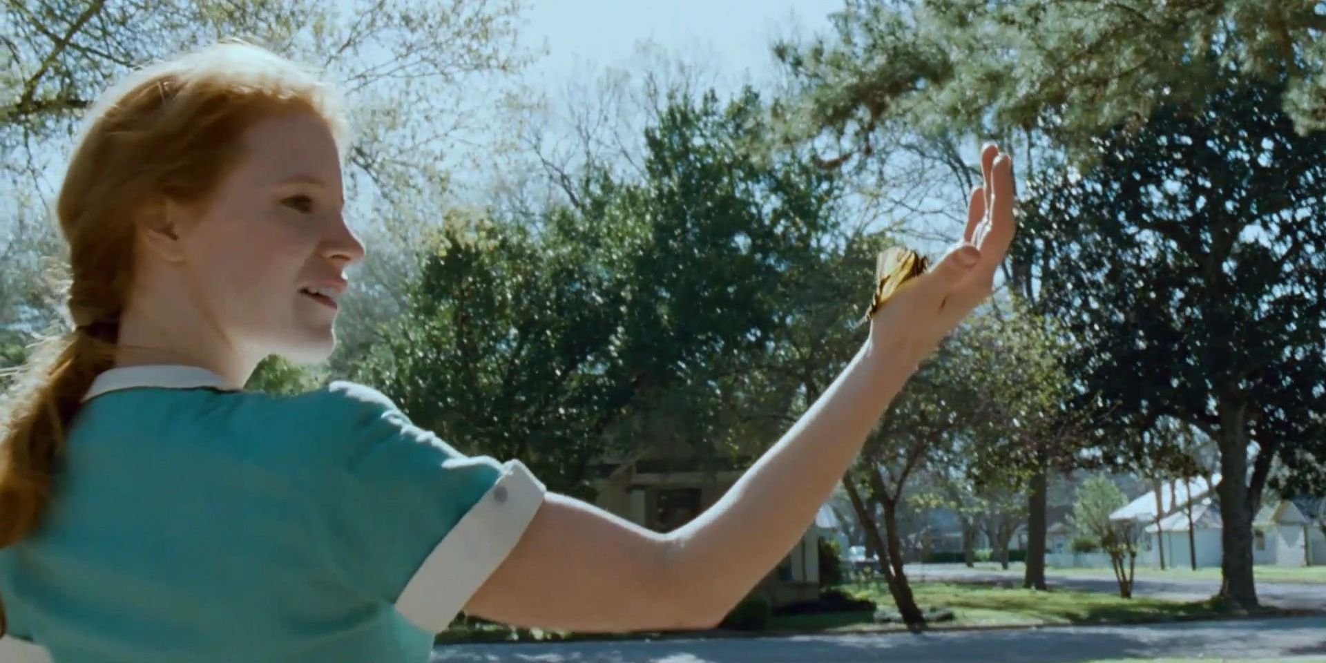 Jessica Chastain admiring a butterfly 