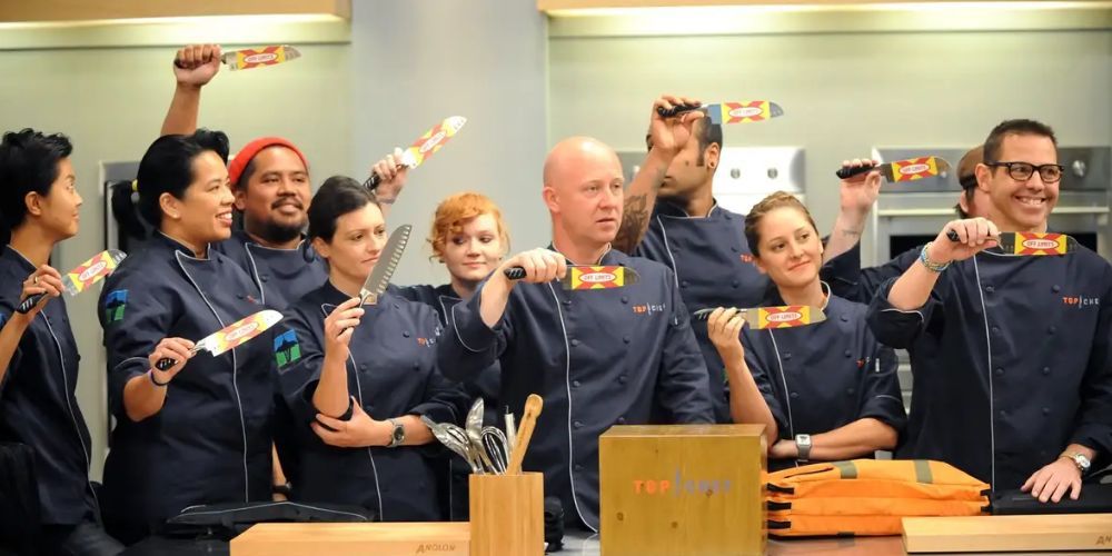 The chefs participating in Top Chef Seattle hold their knives.