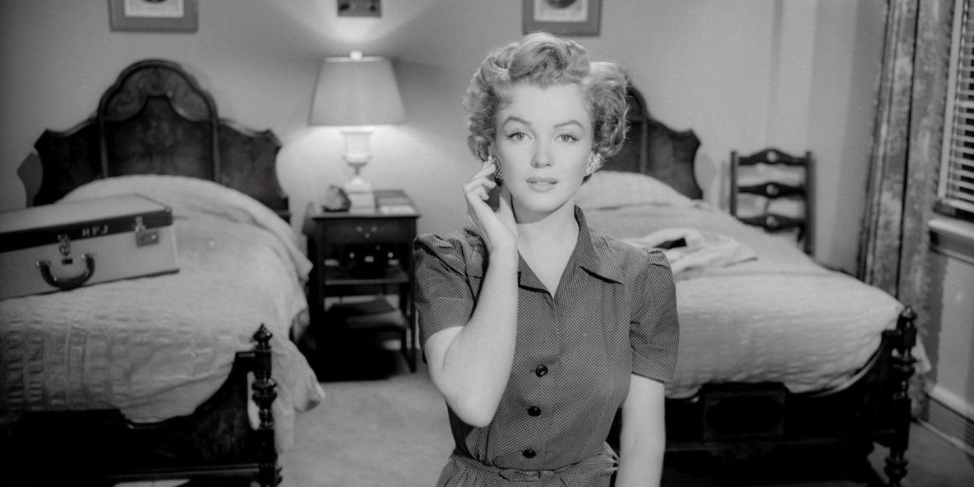 Marilyn Monroe sits and touches her earring in Don't bother knocking.
