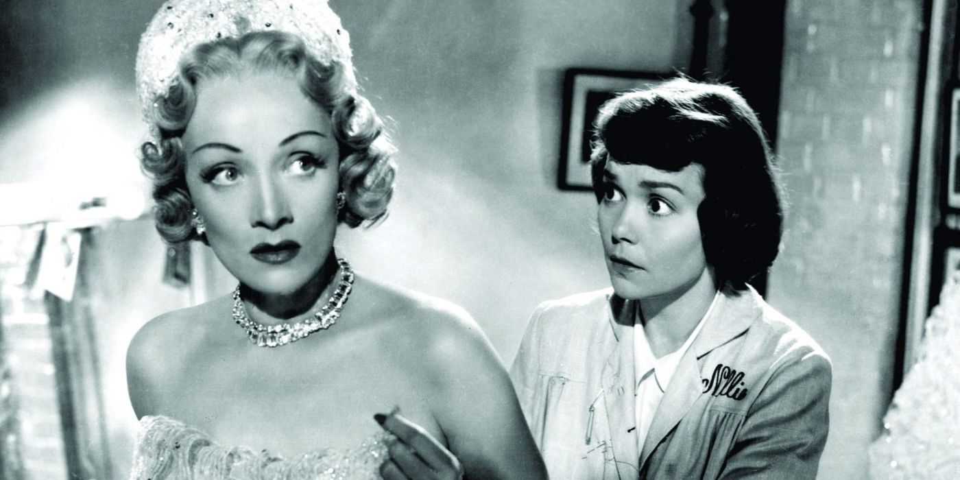 Jane Wyman zips up the back of Marlene Dietrich's dress in Stage Fright.