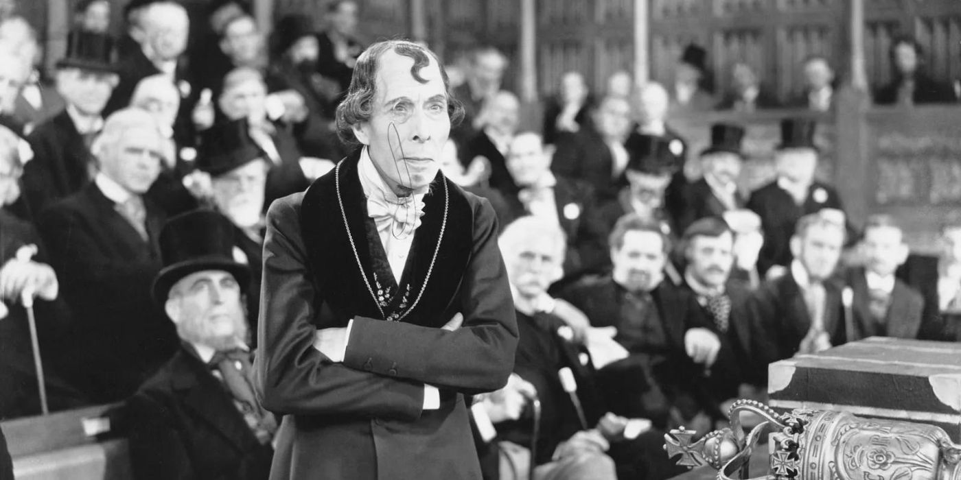 George Arliss as Prime Minister Benjamin Disraeli with arms crossed in Disraeli
