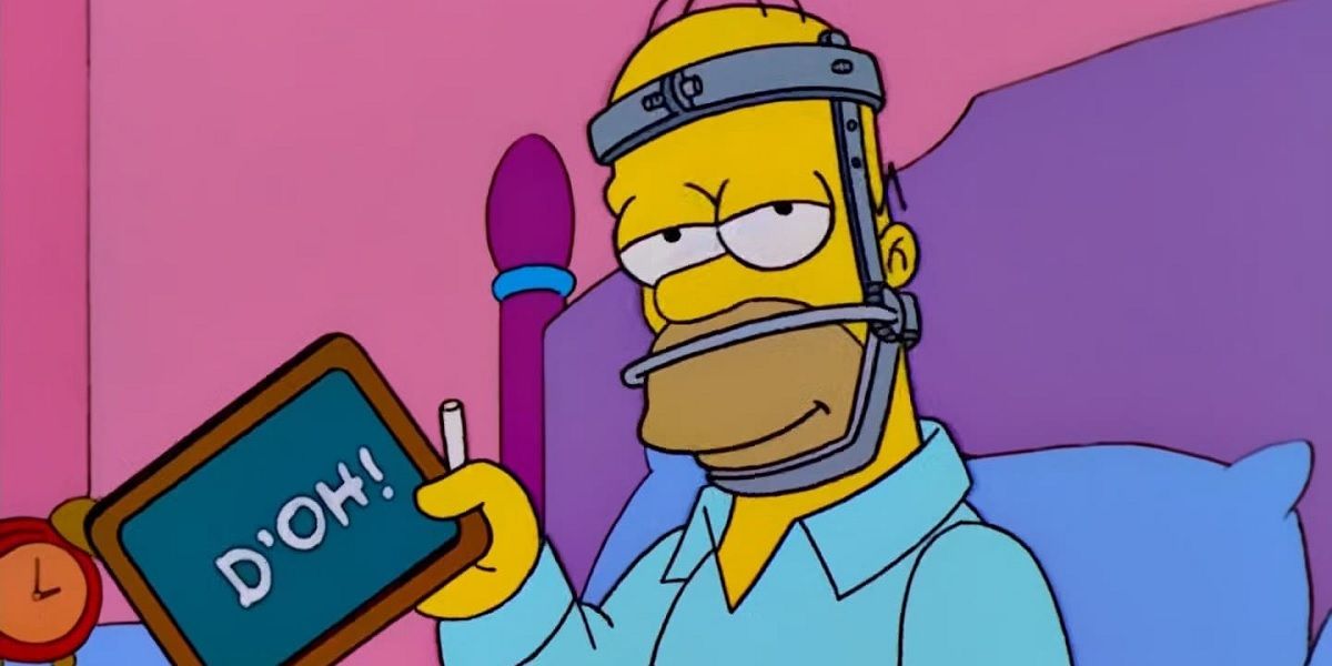 Homer Simpson (Dan Castellaneta) draws with chalk on a blackboard. 