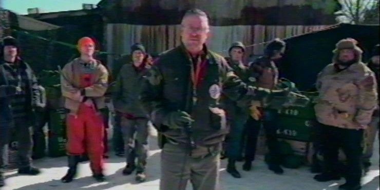 Shot from a VHS/94 videotape: a group of men speak to the camera.