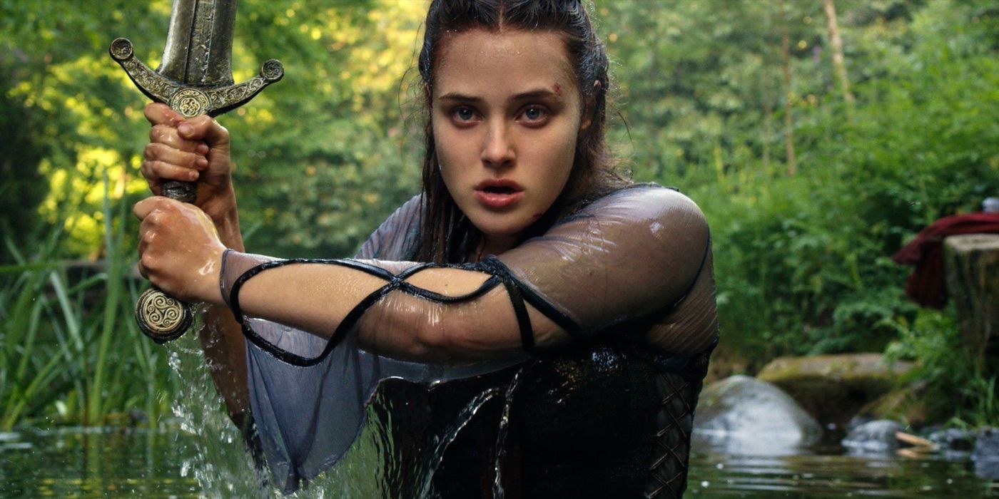 A young woman emerging from a lake with a sword in The Damned.