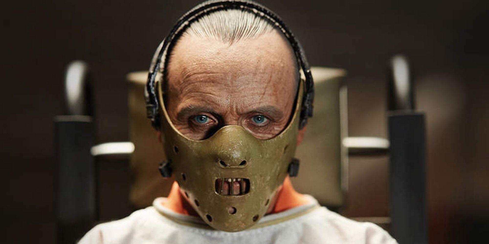 Hannibal Lecter wearing a muzzle and staring at the camera in The Silence of the Lambs.