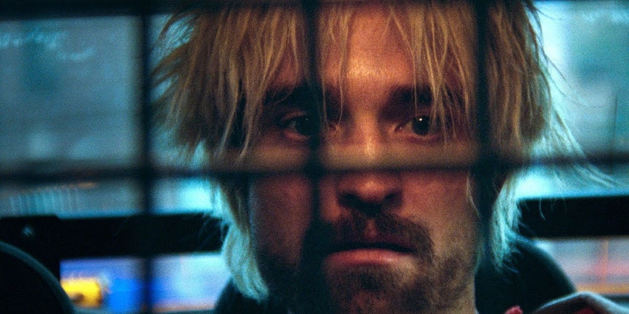 Robert Pattinson in the back of a police car as Connie Nikas in Good Time.