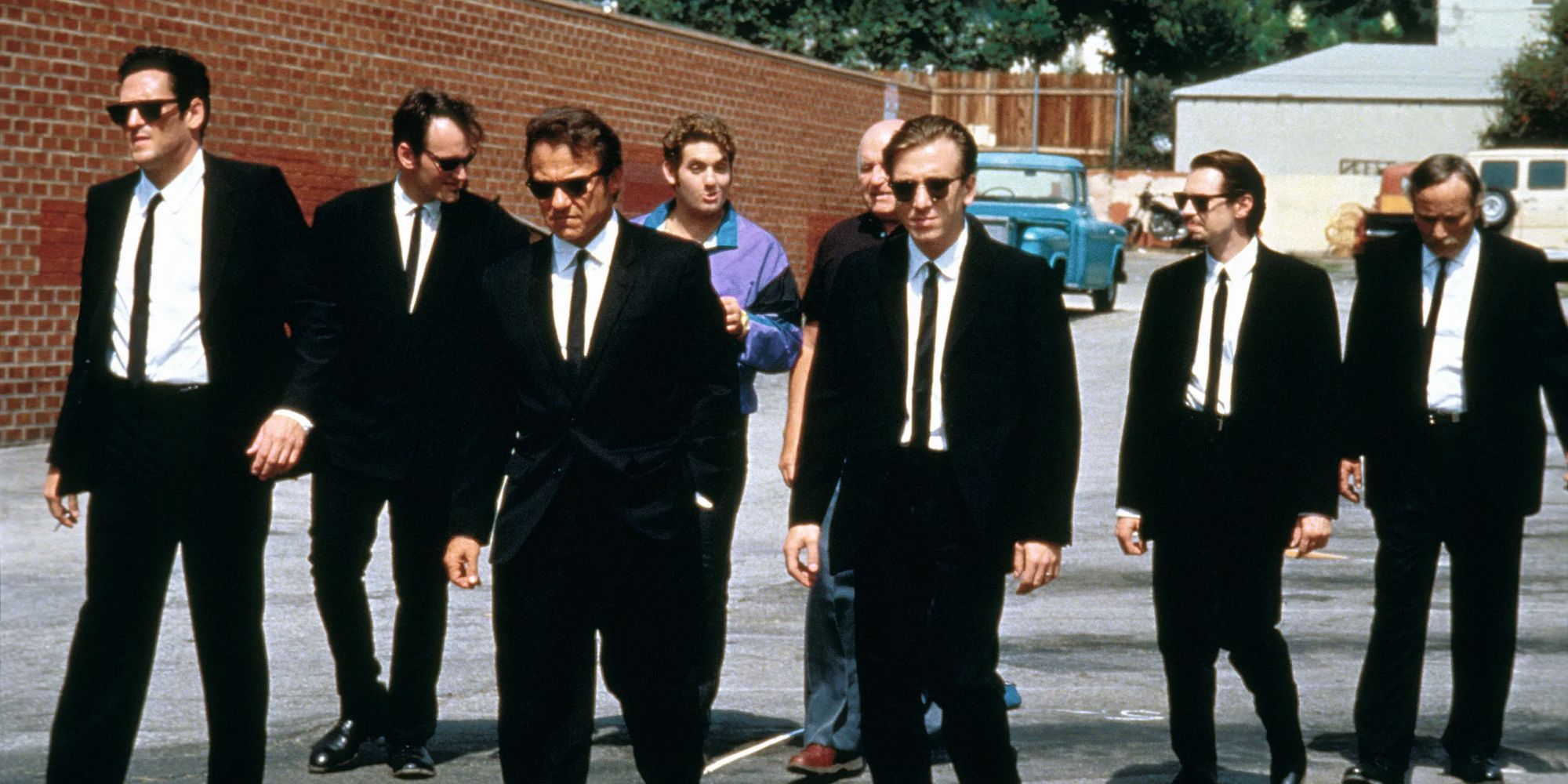 The cast of Reservoir Dogs in their characters in black suits. 