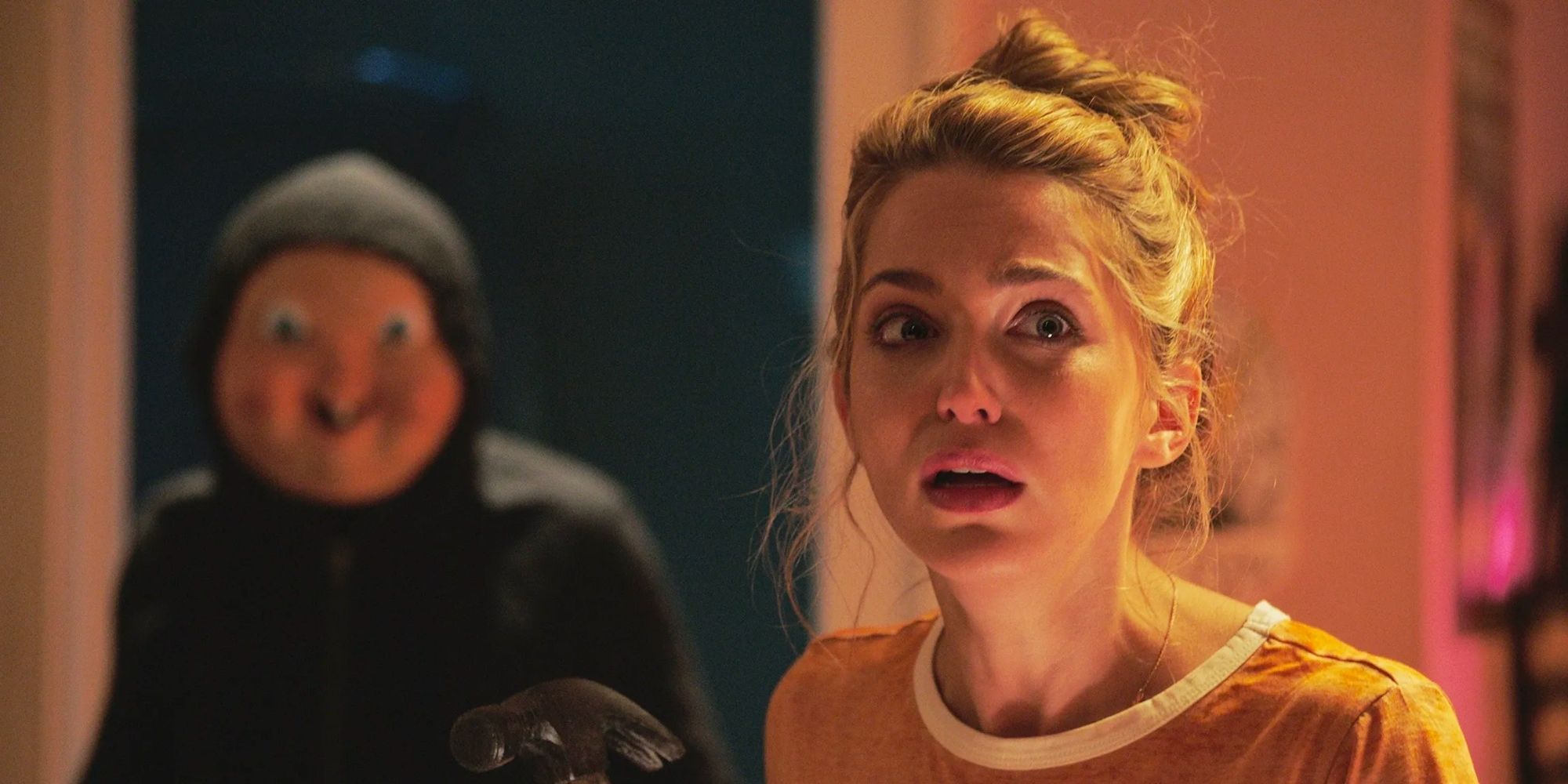 A masked killer sneaks up on Jessica Roth in Happy Death Day.