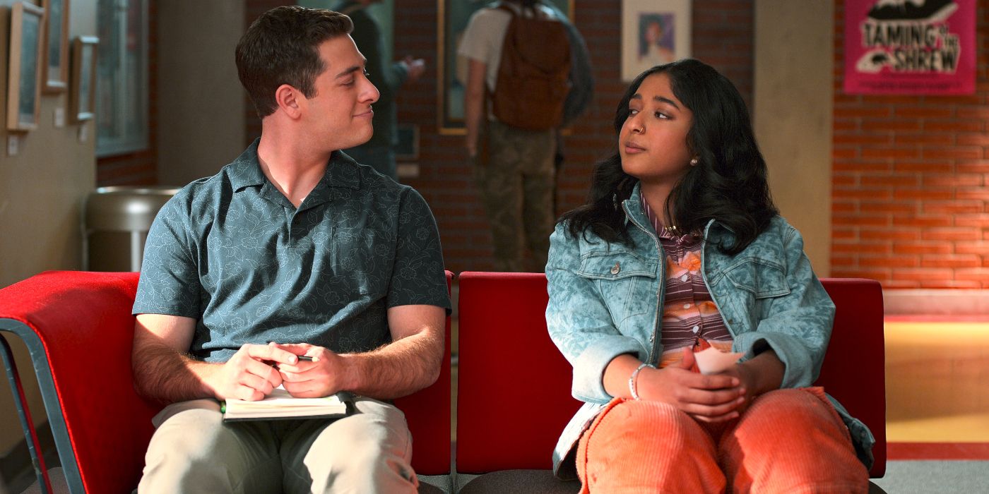 Ben and Devi look at each other as they sit side by side in Never Me Never.