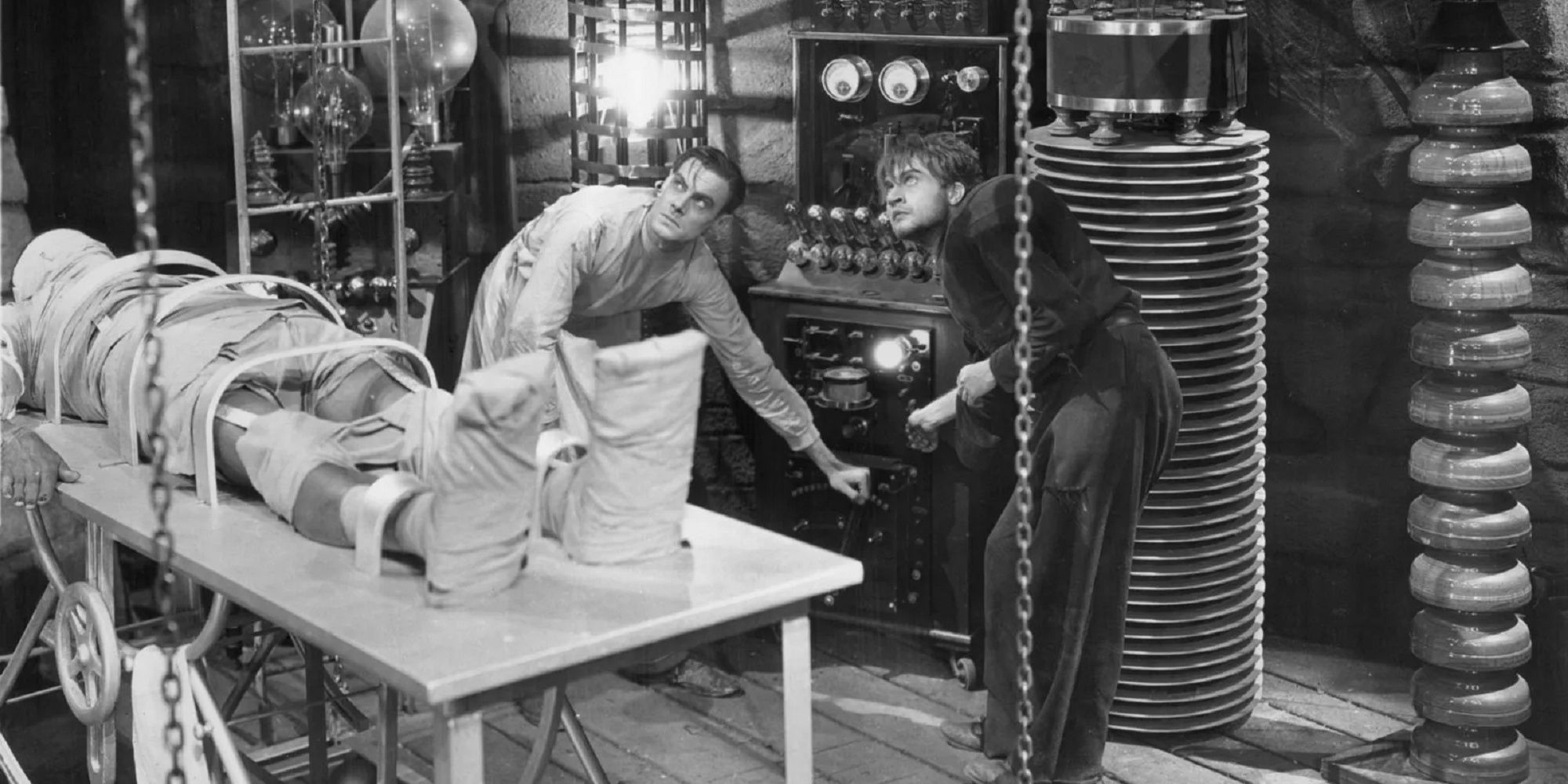 Dr. Frankenstein in his science lab with his monster on the table.