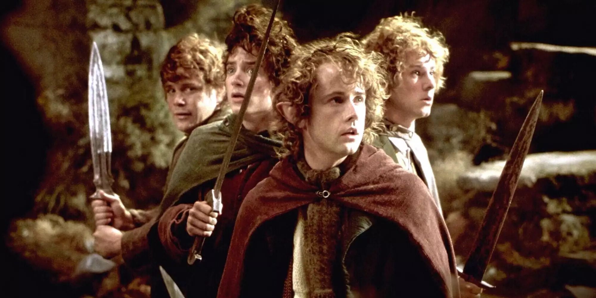 Hobbits Frodo, Sam, Merry and Pippin hold swords on Weathertop in The Lord of the Rings: The Fellowship of the Ring.