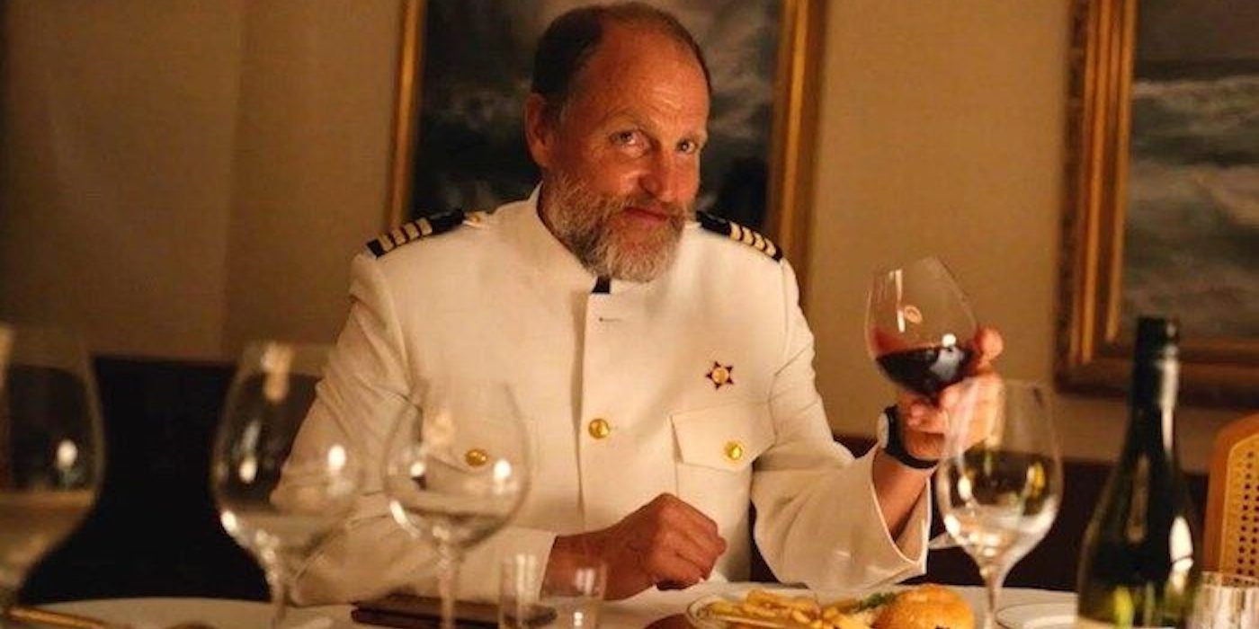 Captain toast with a glass of wine, smiling in the Triangle of Sorrow.