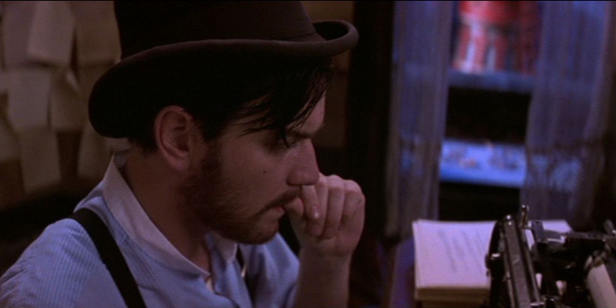 Ewan McGregor as Christian sitting at his typewriter at the Moulin Rouge!