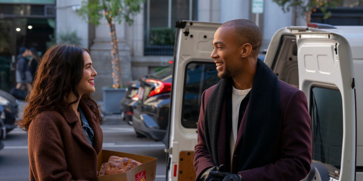 Zoey Deutch and Kendrick Sampson smile at each other near the white van.