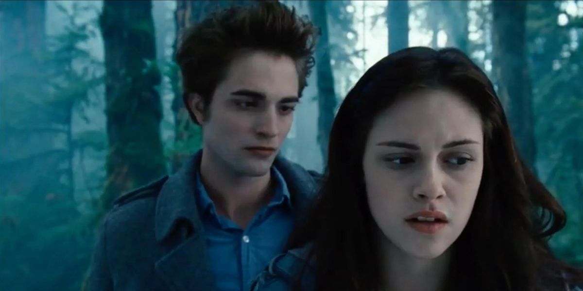 Robert Pattinson as Edward and Kristen Stewart as Bella in the woods in Twilight.