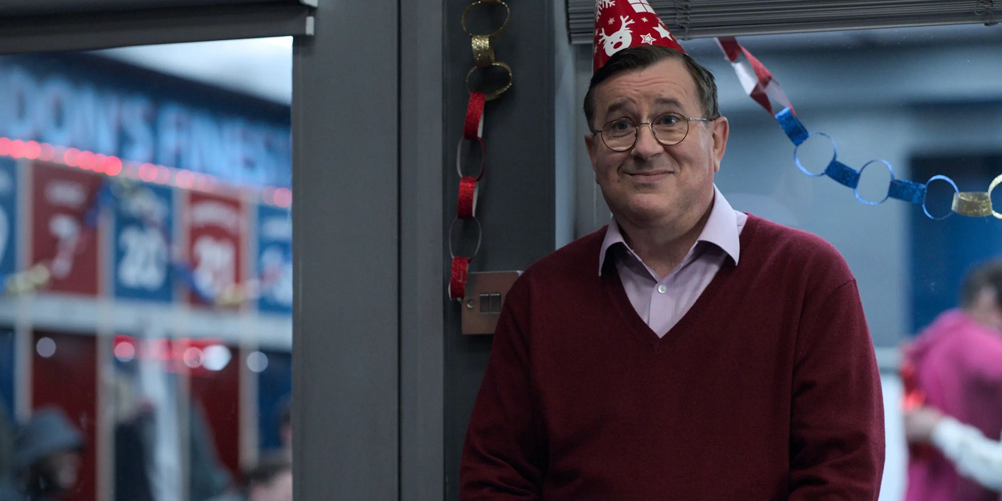 a man in a sweater, a festive hat and with an awkward expression on his face