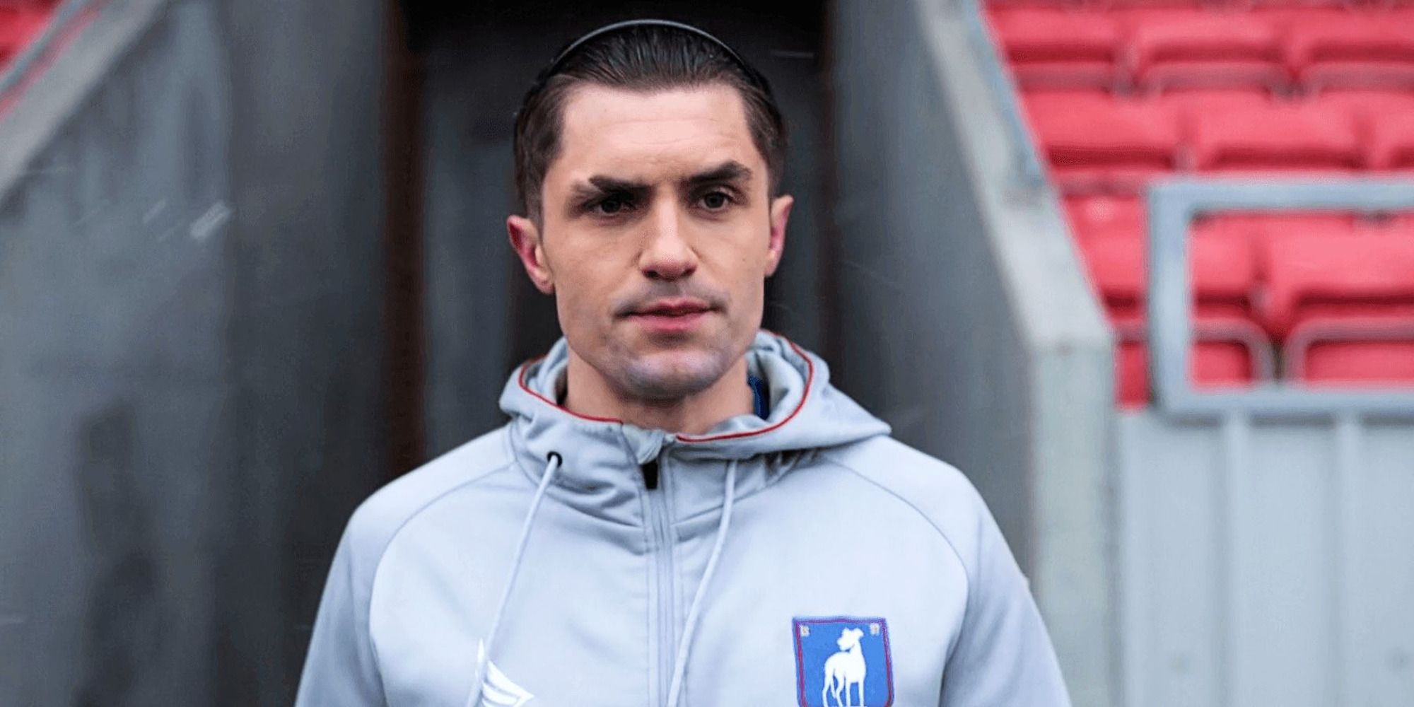 Jamie Tartt wearing a hairband in a football jersey in a scene from Ted Lasso.