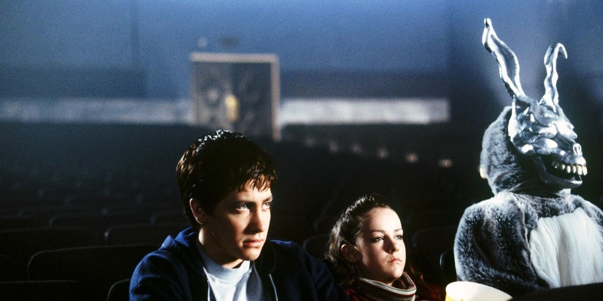 Jake Gyllenhaal sits in a movie theater in Donnie Darko.