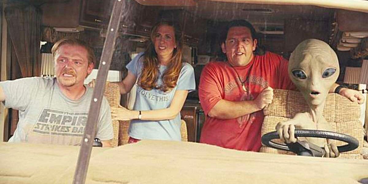 The alien is driving the van as the passengers watch in concern.