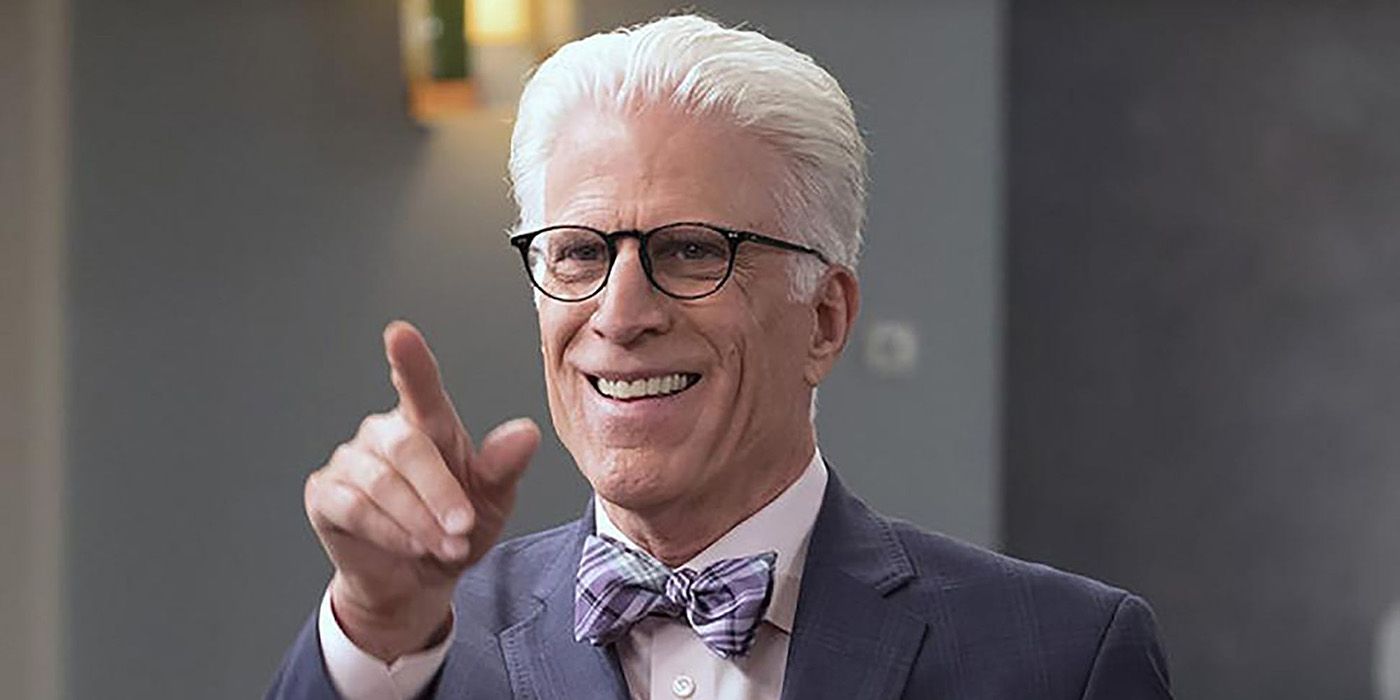 Michael smiles and points at someone in The Good Place.