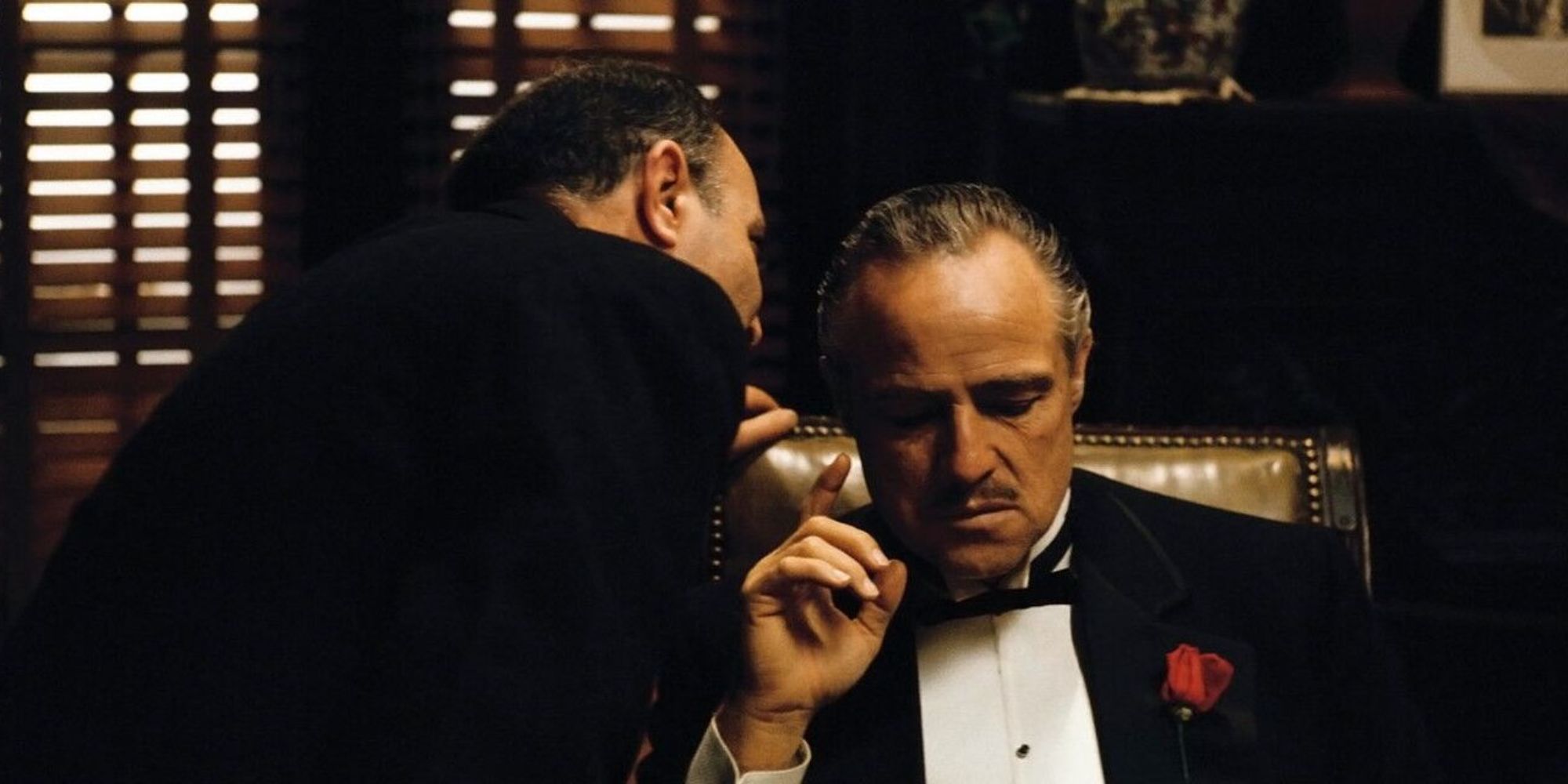 Man whispering in Marlon Brando's ear in The Godfather (1972) (1)