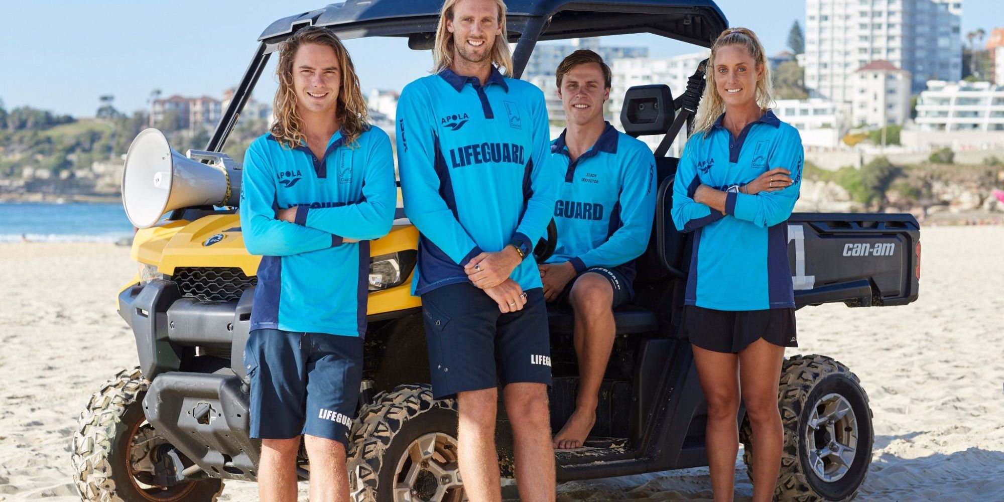 Four Bondi rescuers pose next to a buggy 